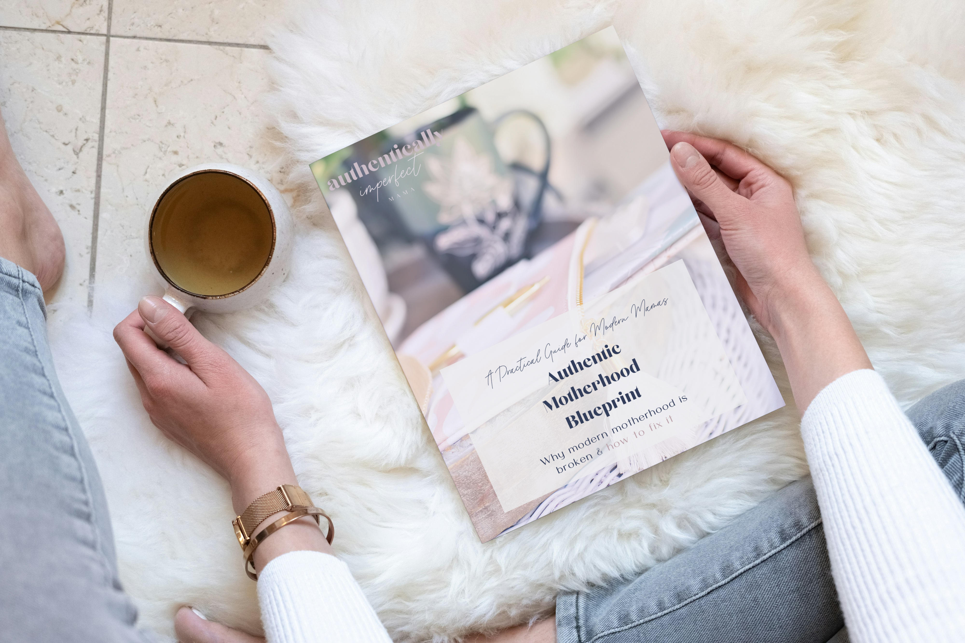 Authentic Motherhood Blueprint - woman reading with cup of coffee on cozy rug